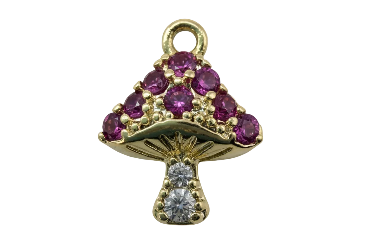 Gold mushroom charm with purple faceted gems and clear crystal accents