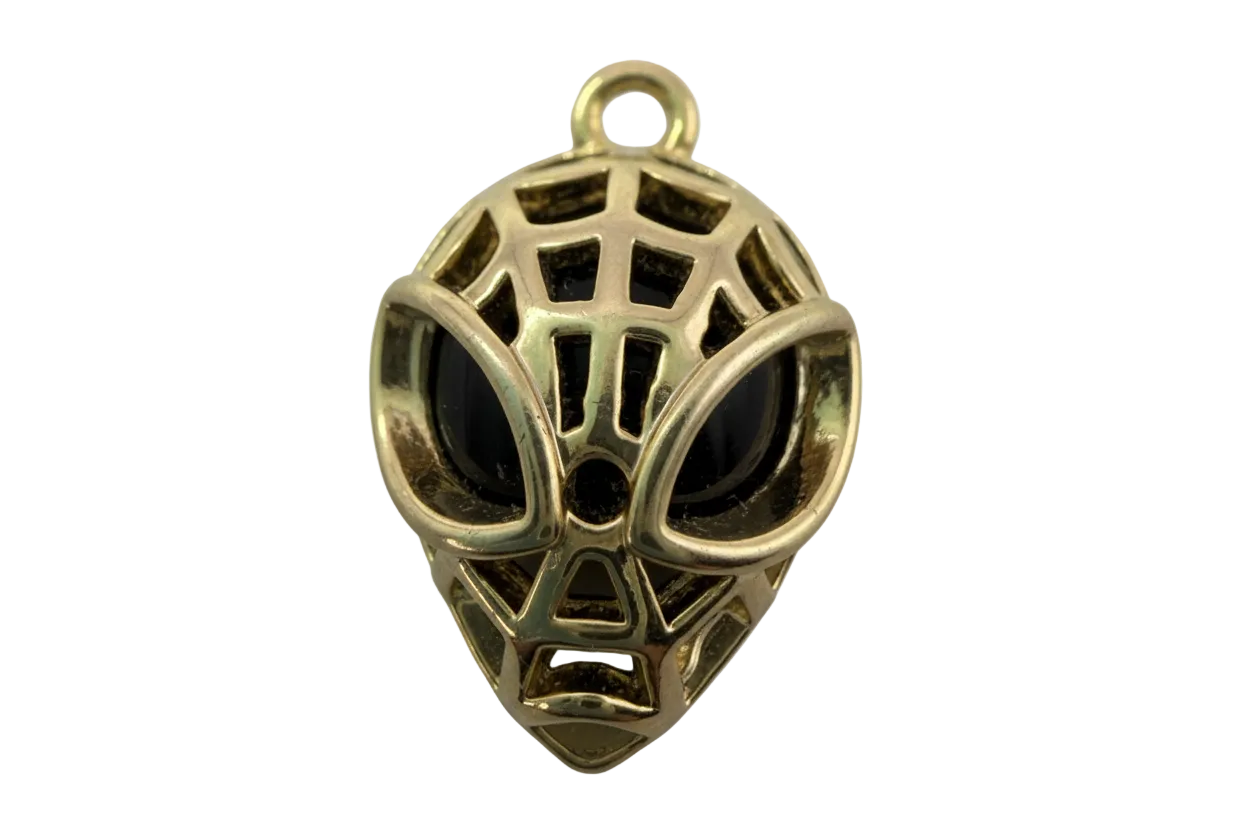 Polished gold webbed mask face charm with black inlay and openwork details
