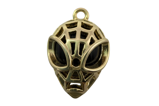 Polished gold webbed mask face charm with black inlay and openwork details
