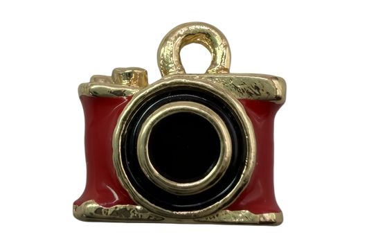 Red enamel camera pendant with black lens and polished gold-tone trim