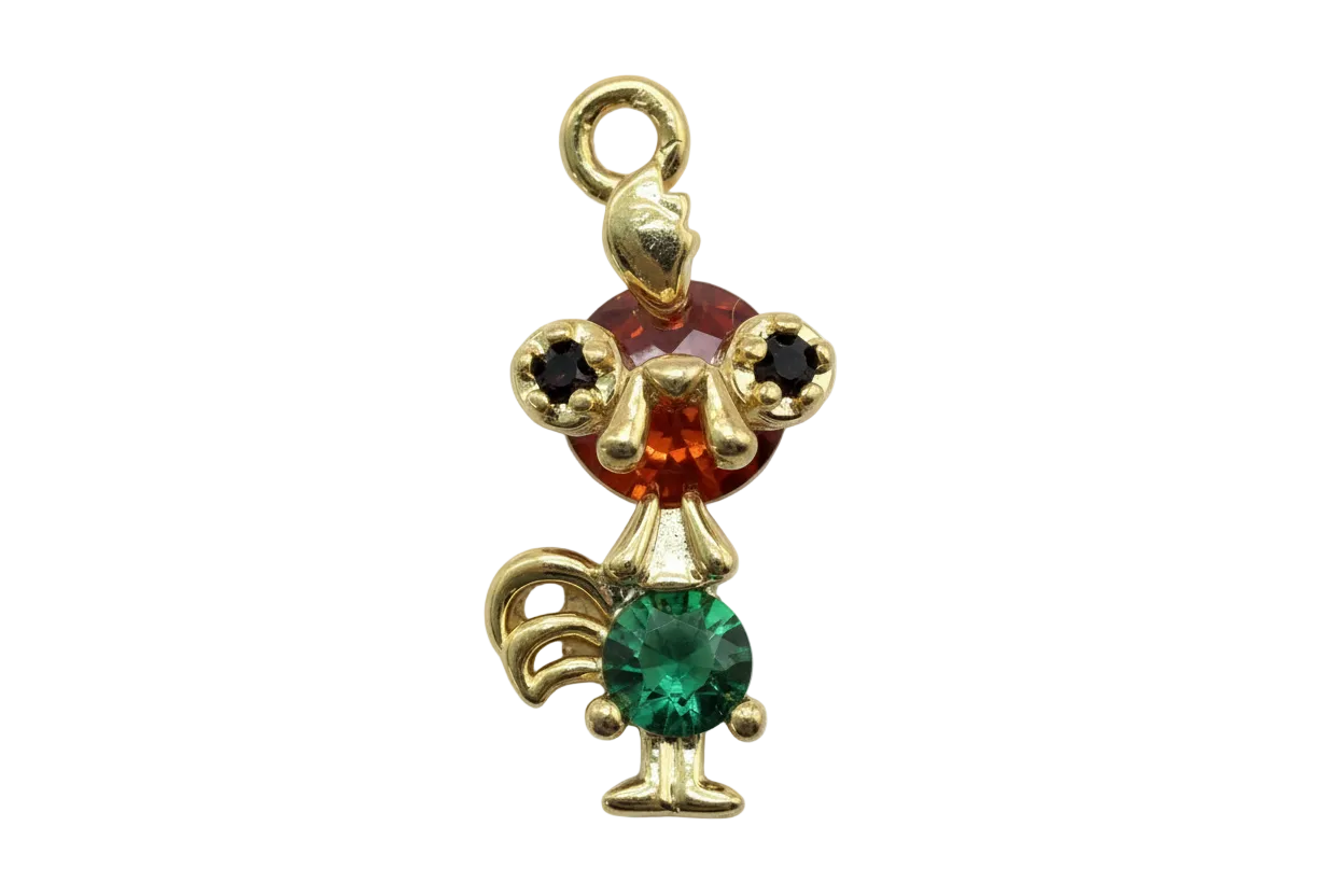 Gold mouse figure with faceted red head gem, green body gem, and black ear stones
