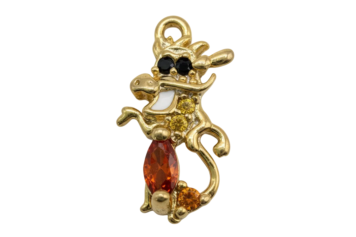 Gold cat silhouette charm with orange marquise gem, amber accents, black eyes, and bow detail