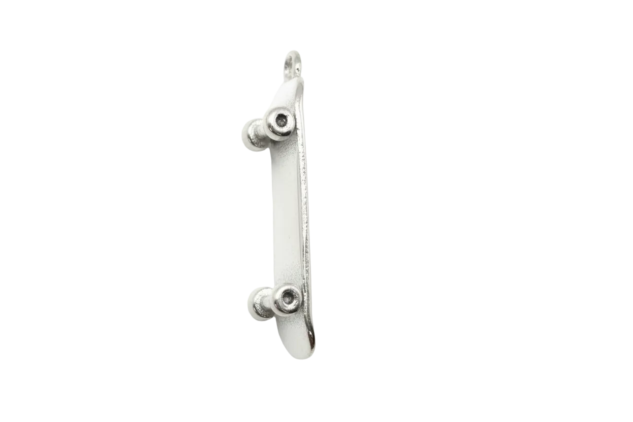 Polished silver miniature skateboard with sculpted truck details