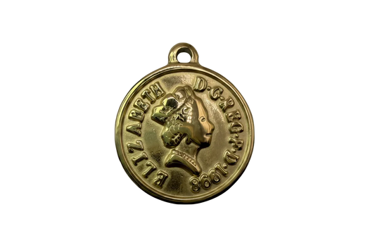 Gold round coin-style medallion with raised profile portrait and embossed lettering, dated 1968