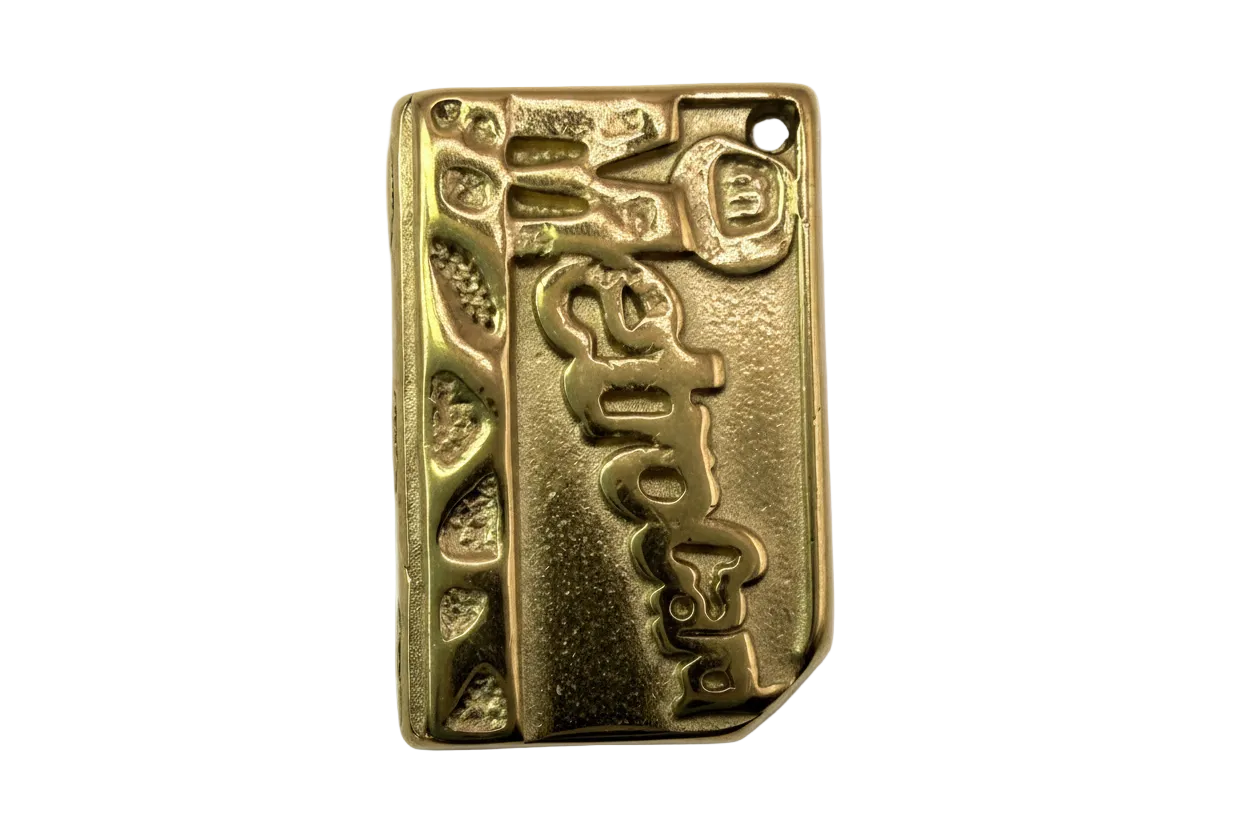 Gold rectangular plaque charm with embossed espresso lettering and textured side details