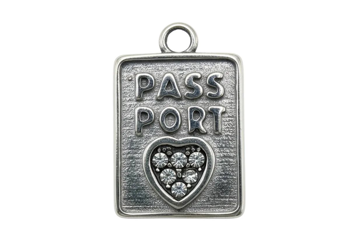 Antique-silver passport tag with raised PASS PORT text and heart filled with clear crystals
