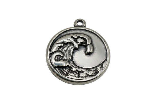 Silver-toned round medallion with raised mushroom and crescent moon motif in an antiqued finish