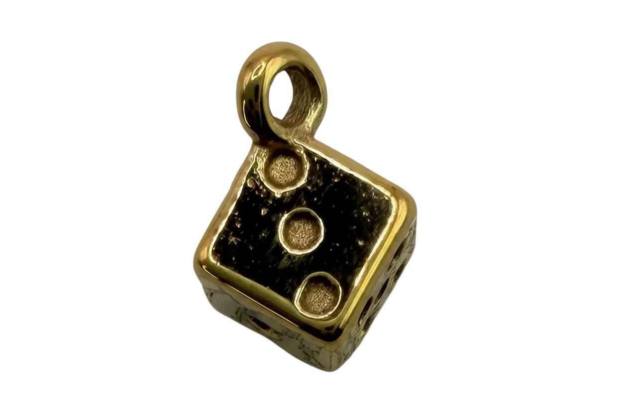Glossy black dice charm with raised gold pips and polished gold border