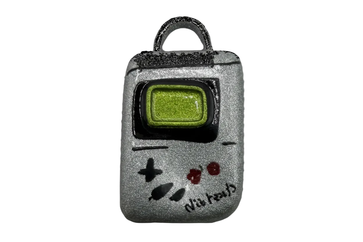 Silver retro handheld game console charm with green screen, black frame, and red buttons