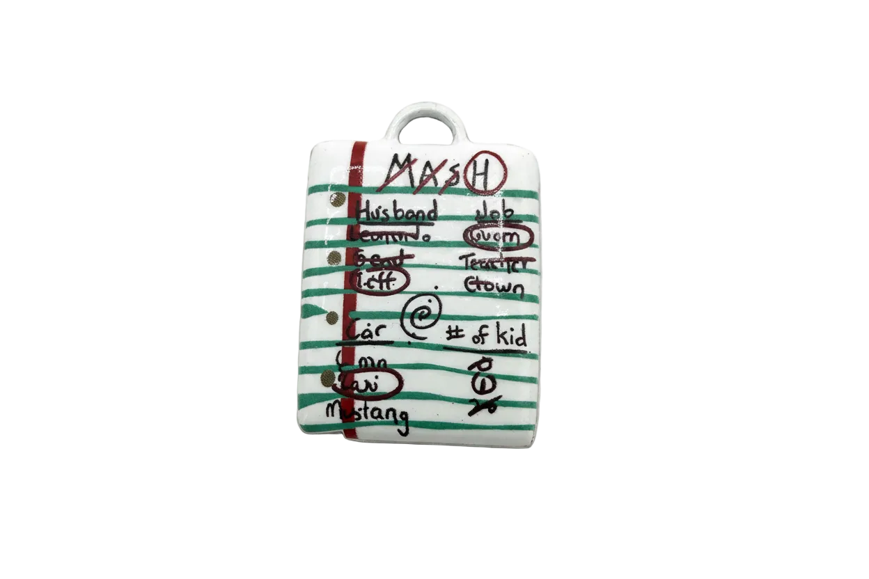 White lined notebook page charm with green stripes, red margin, and handwritten black doodles