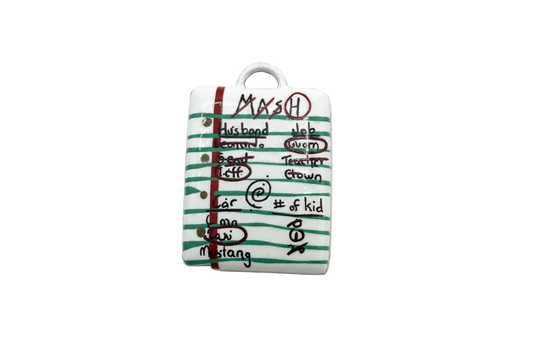 White lined notebook page charm with green stripes, red margin, and handwritten black doodles