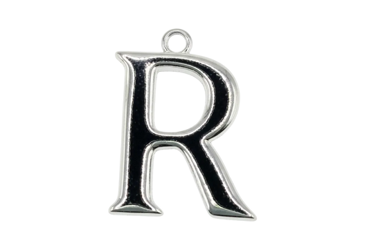 Polished silver-tone letter R initial charm on black background