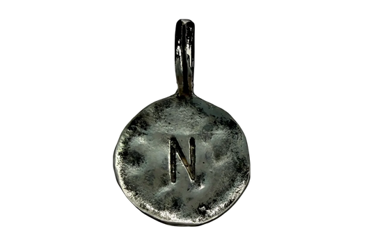 Round hammered silver coin charm with stamped letter N and oxidized texture
