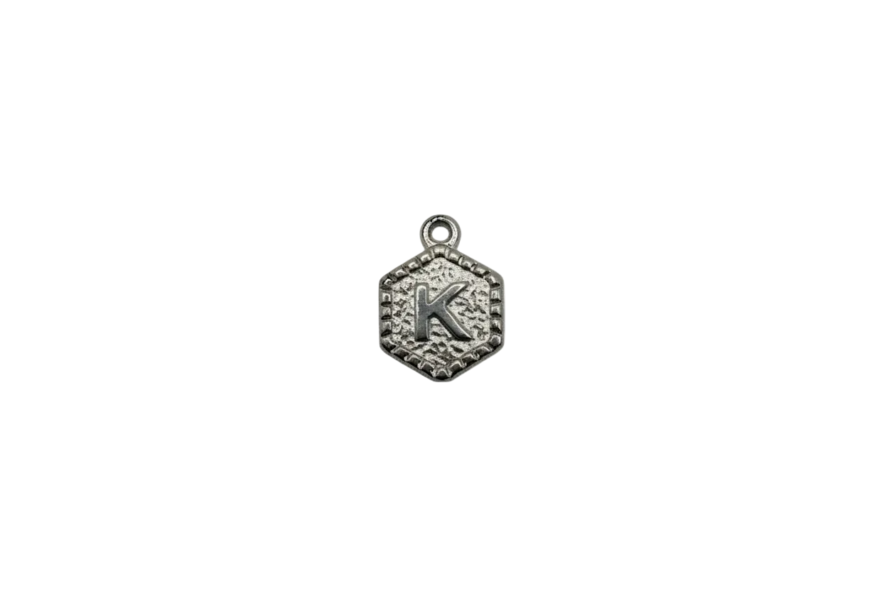 Antiqued silver medallion with raised letter K