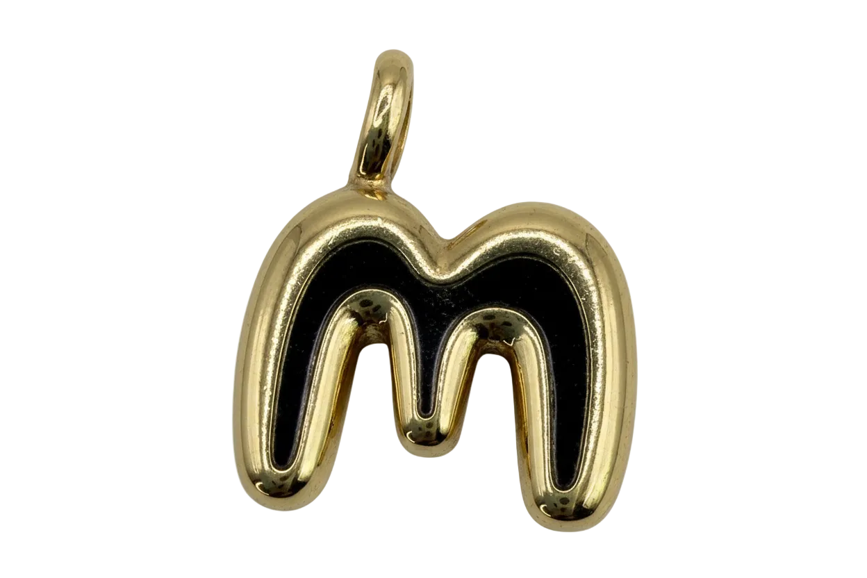 Polished gold letter M initial with rounded sculpted shape on black background