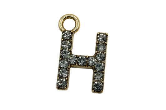 Gold letter H charm with clear faceted stones in a pavé layout