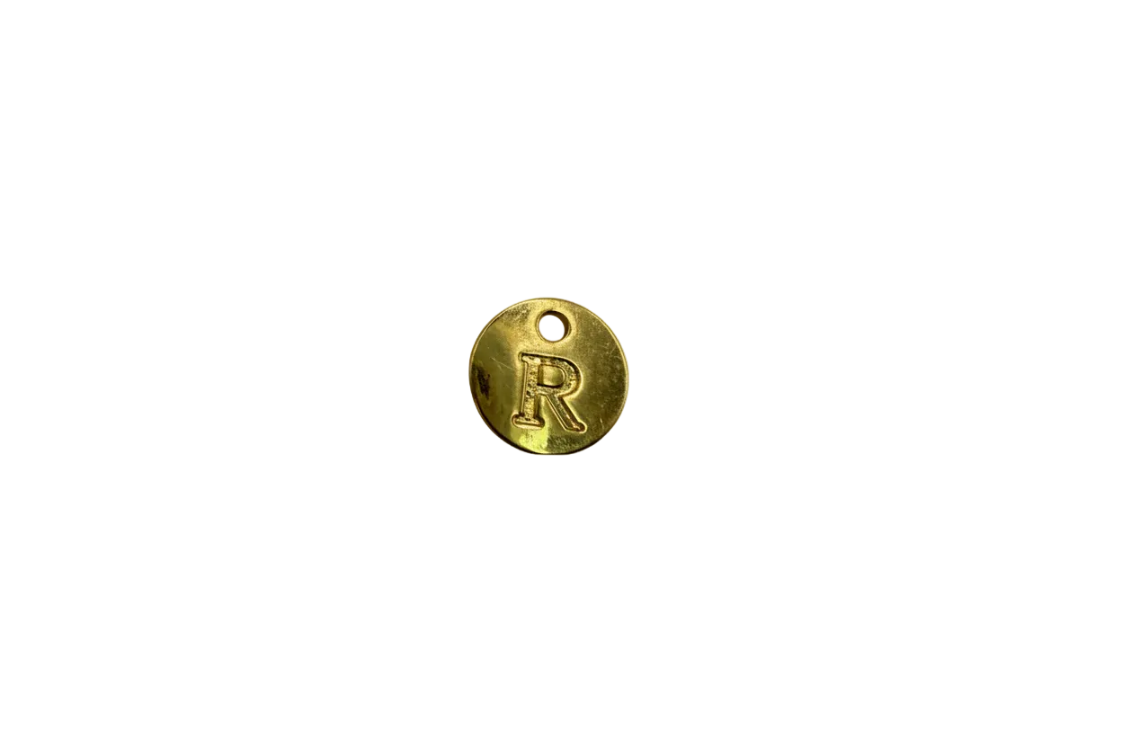 Gold disc with raised letter R