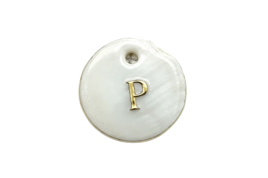 Round white disc with raised gold letter P on a glossy surface