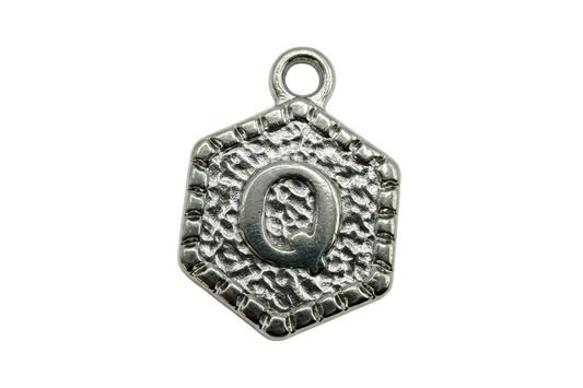 Antique silver square tile with textured surface and raised letter Q