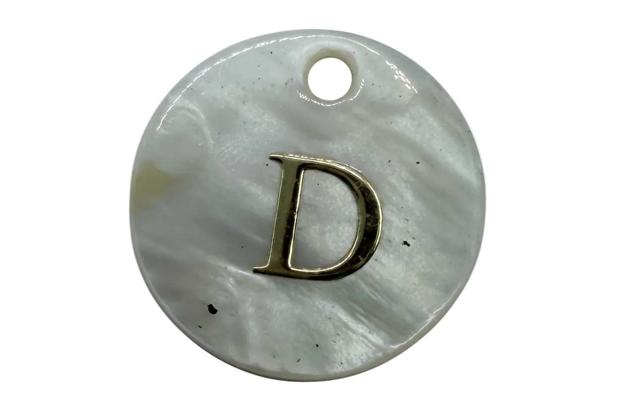 Iridescent white mother-of-pearl disc with raised gold letter D