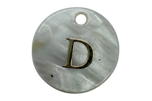 Iridescent white mother-of-pearl disc with raised gold letter D