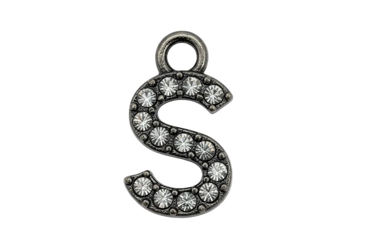Silver letter S initial with pavé clear crystals on a black background