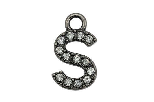 Silver letter S initial with pavé clear crystals on a black background