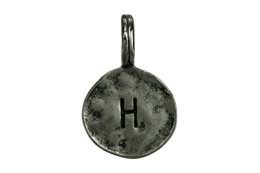 Antiqued silver round coin charm with stamped letter H and darkened patina