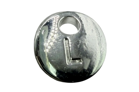 Polished silver round coin charm with raised letter L and small clear gem accent