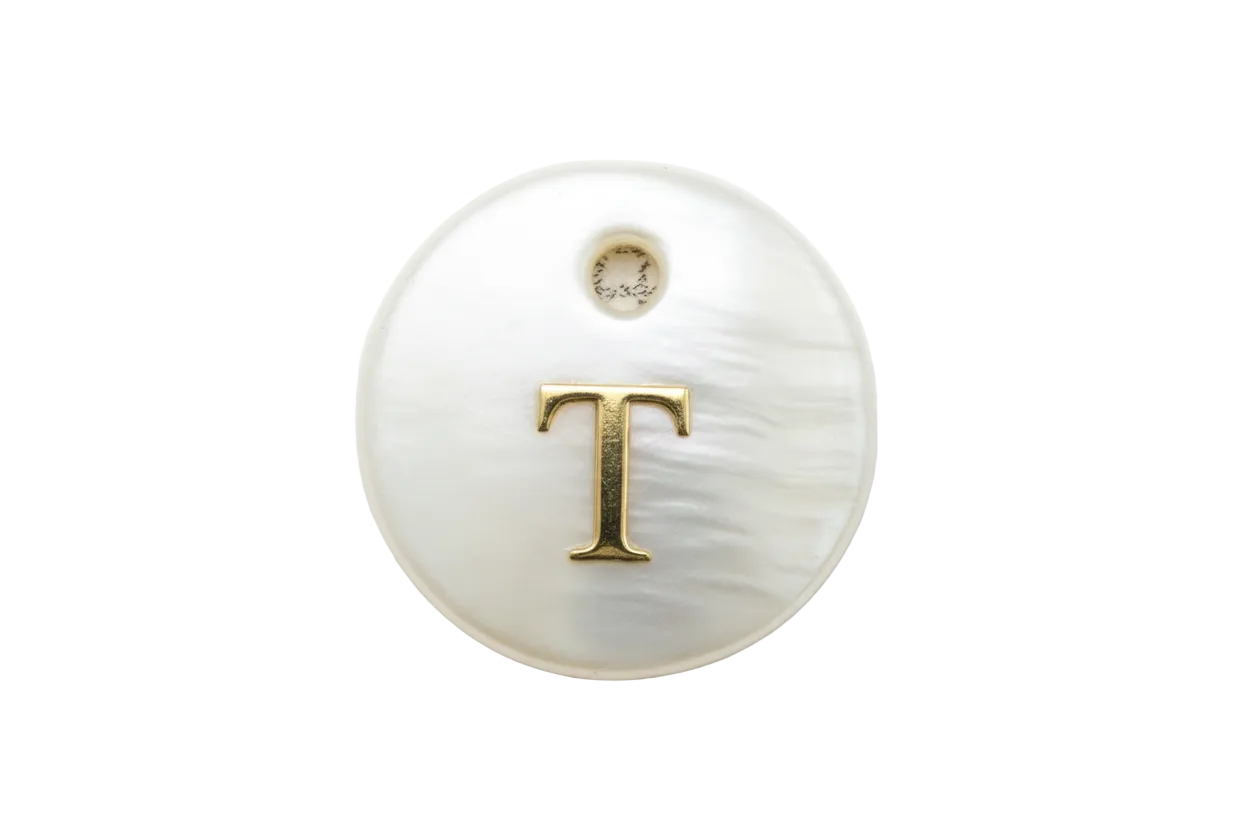 Pearl-white iridescent round disc with raised gold letter T