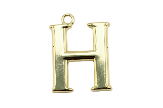 Polished gold serif letter H initial with glossy finish