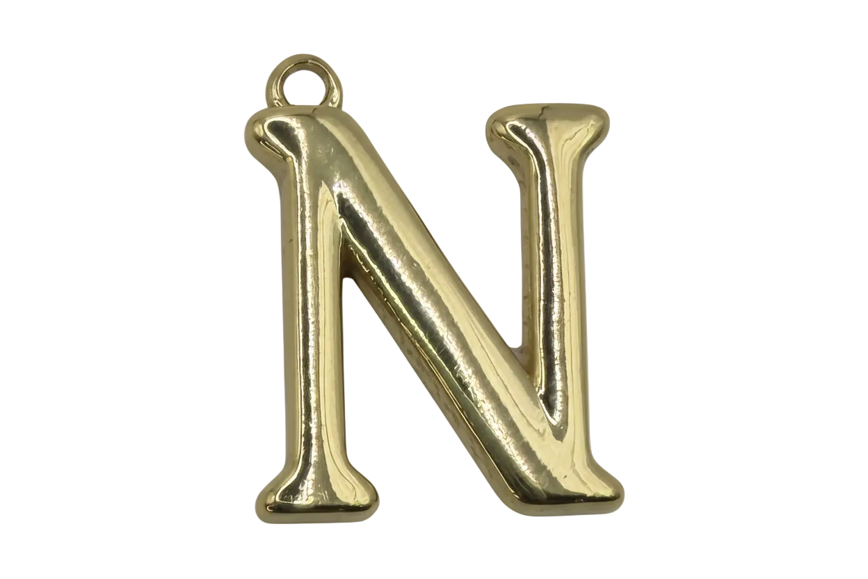 Gold puffed letter N initial with a small clear gem accent