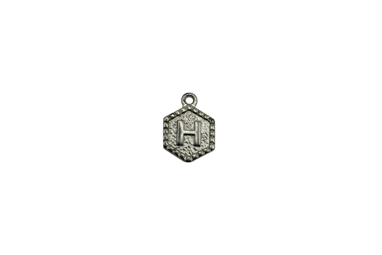 Silver-tone hexagon medallion with raised letter H