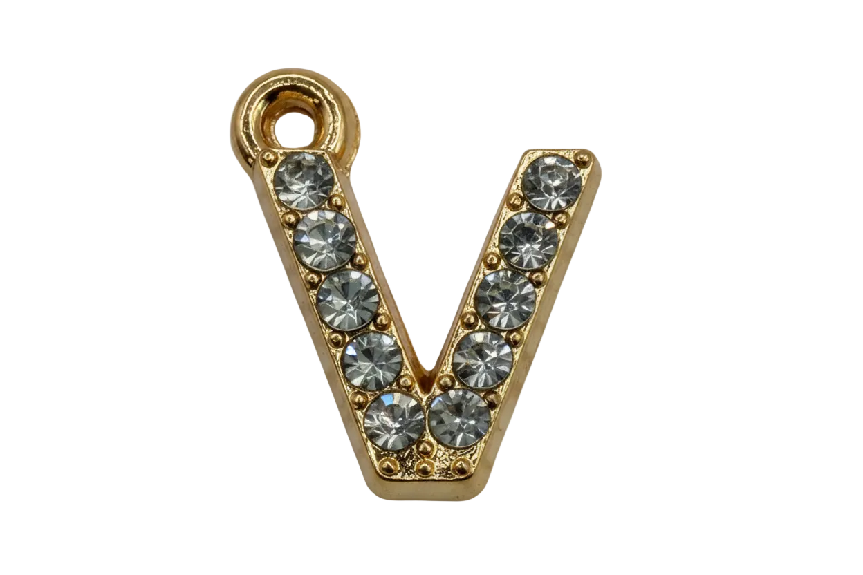 Gold letter V with clear pavé crystals on black background