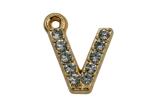 Gold letter V with clear pavé crystals on black background