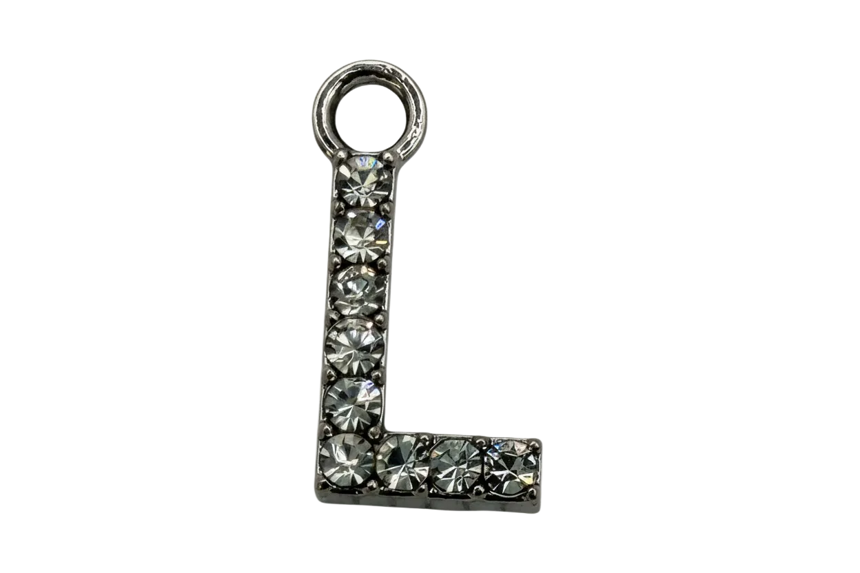 Silver letter L initial with pavé clear faceted stones on a black background