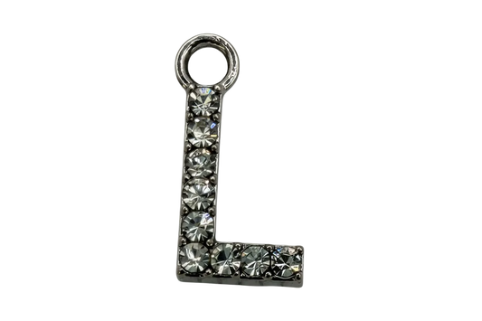 Silver letter L initial with pavé clear faceted stones on a black background