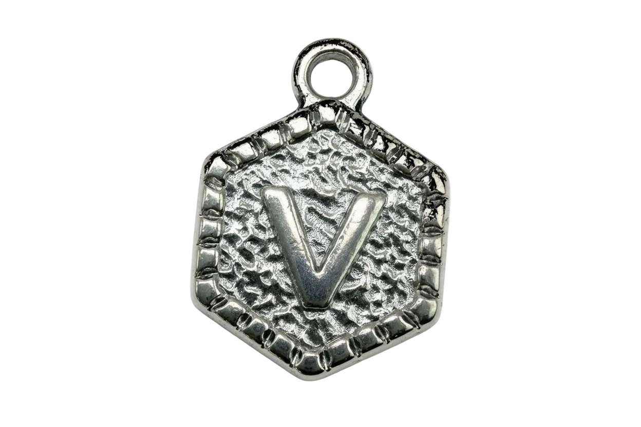 Silver-toned textured hexagon medallion with raised letter V