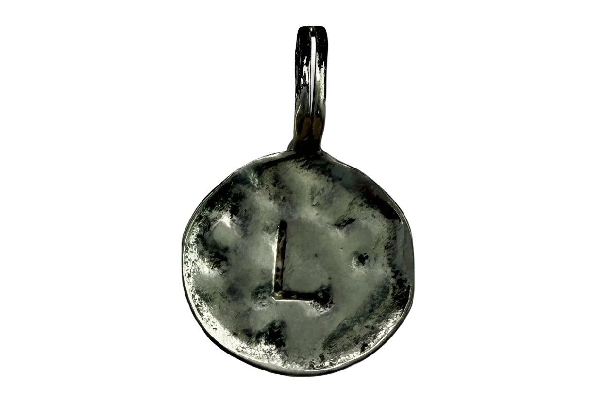 Antiqued silver round initial coin featuring a recessed letter L