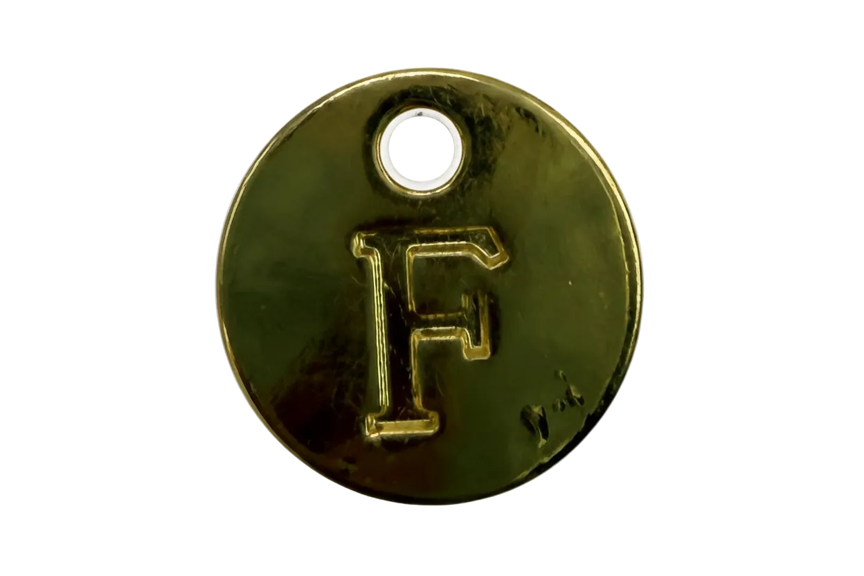 Polished gold round disc with raised letter F