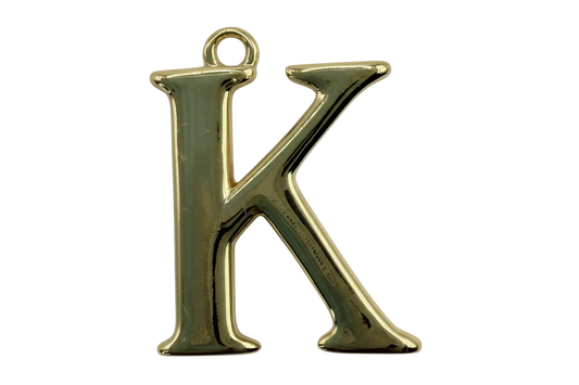 Polished gold letter K initial charm with high-shine metal finish