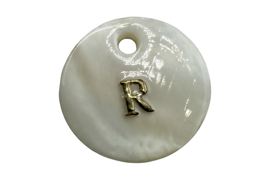 Glossy white round disc with raised gold letter R