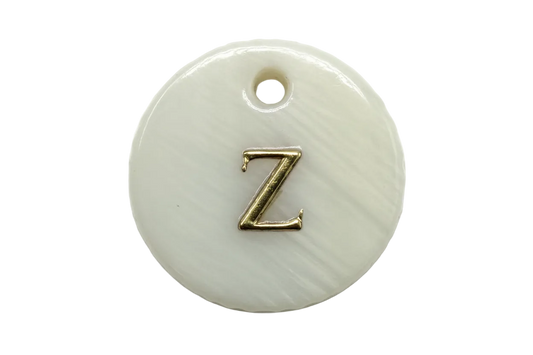 Glossy white round disc with raised gold letter Z