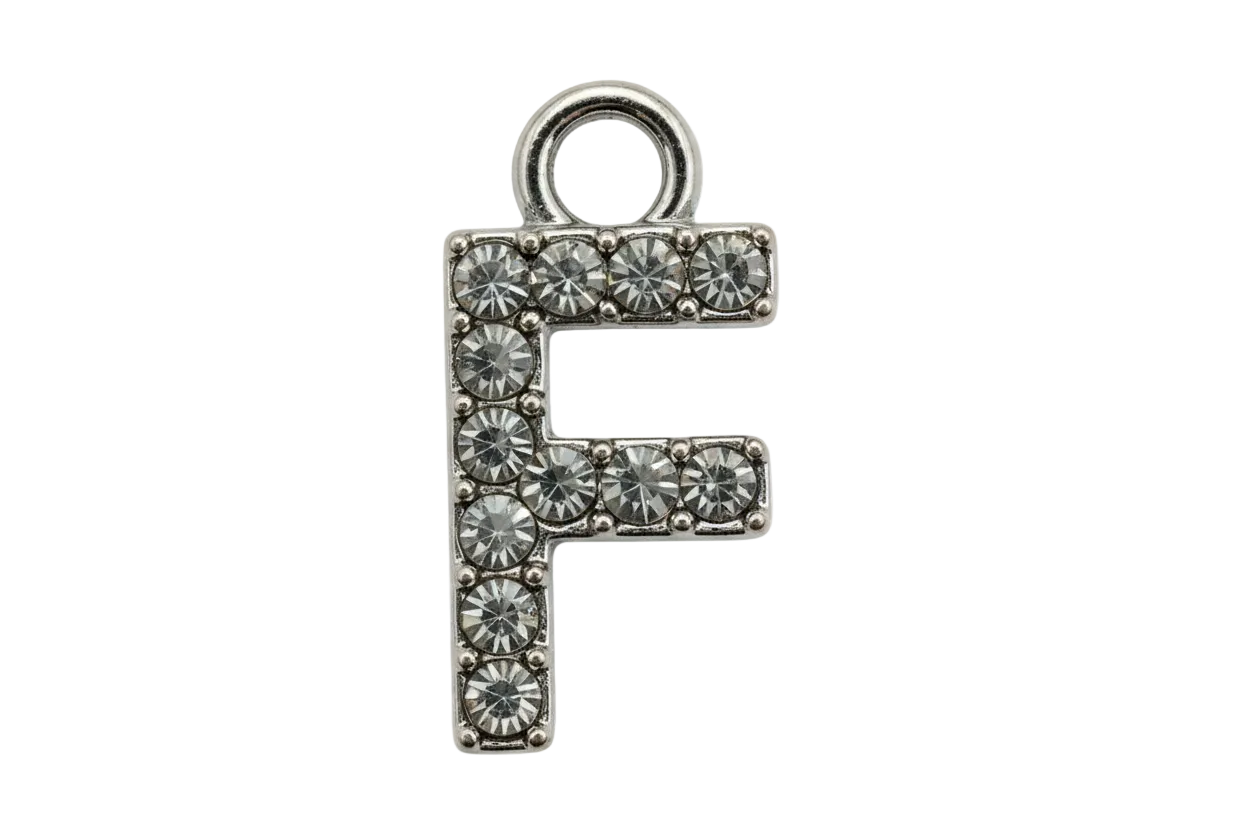 Silver letter F initial with pavé clear crystals on a black background