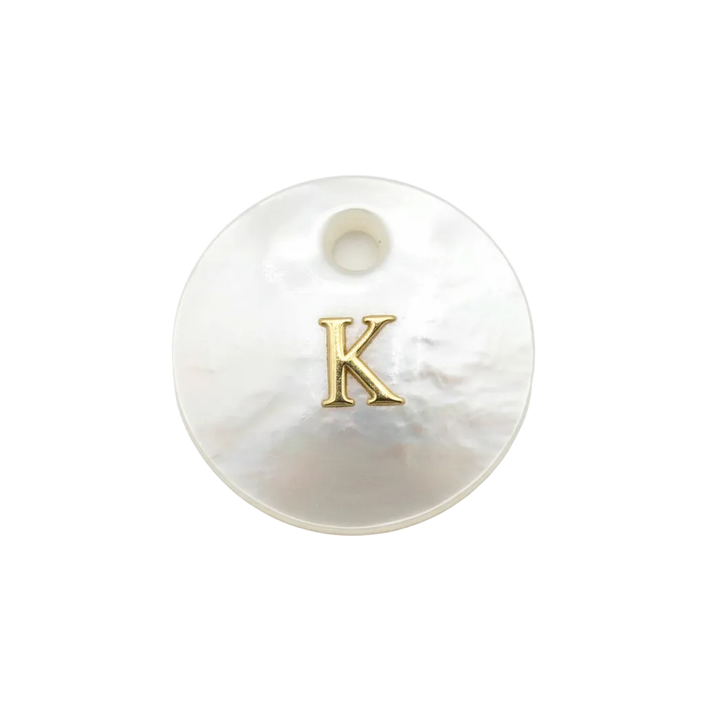 Iridescent mother-of-pearl disc with raised gold letter K