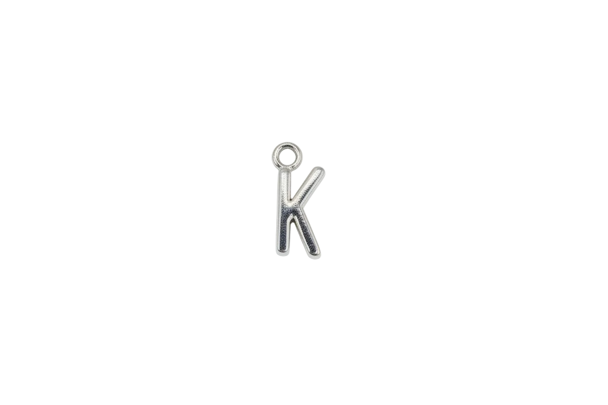 Polished silver letter K initial charm on a dark background