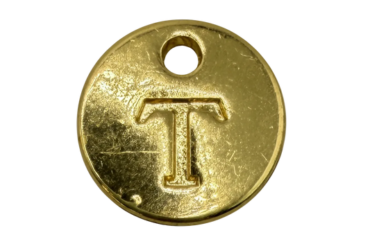 Round gold coin with engraved letter T and small top hole