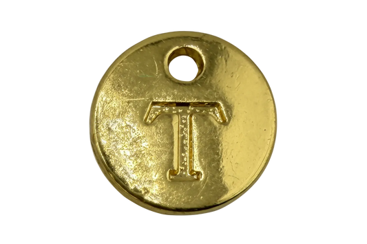 Round gold disc with raised letter T and a small top hole, polished finish