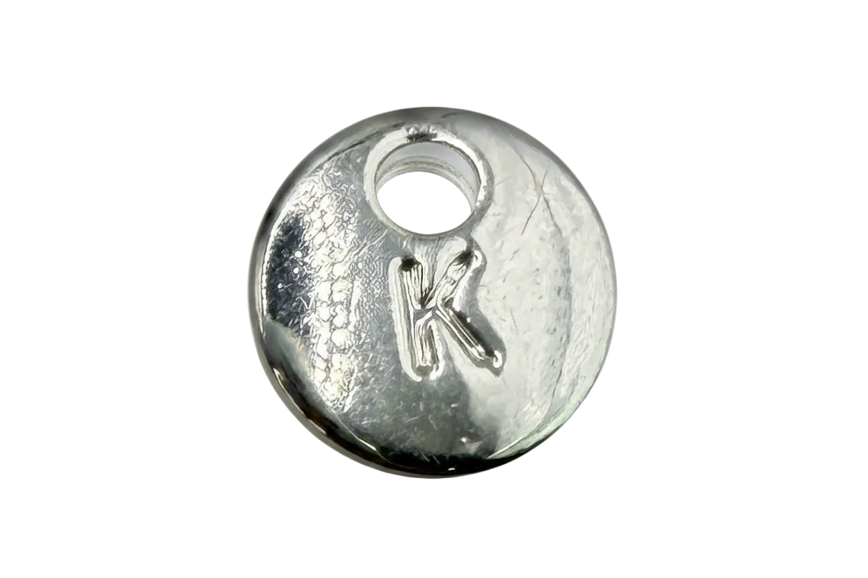 Polished silver round disc with raised letter K initial and subtle texture