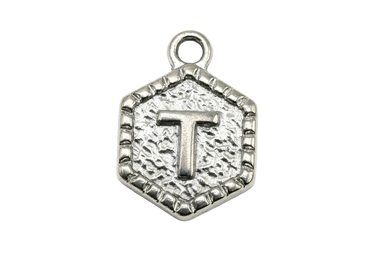 Antiqued silver hexagon medallion with raised letter T and beaded border